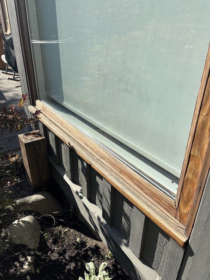 Before - weathered log showing rot and failing finish