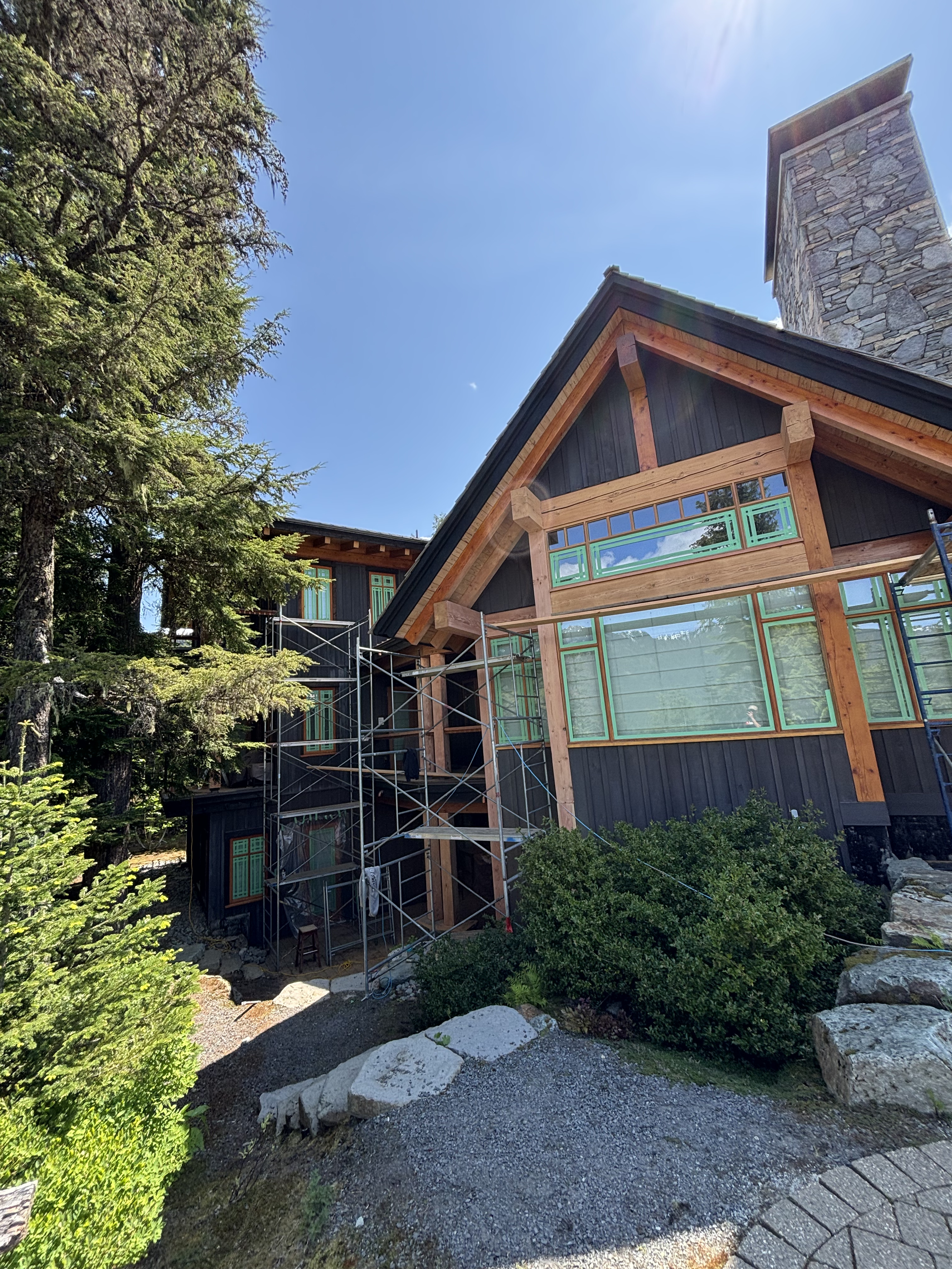 Restored log home exterior with rich stain in Whistler