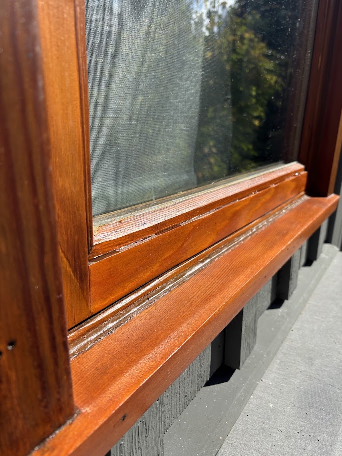 Team applying protective stain to logs